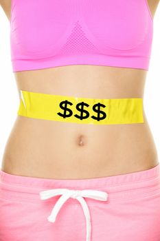 Expensive diet - money and nutrition concept. Closeup of female lower body with label on stomach and abs to show the cost of staying fit by paying for the gym, eating healthy and dieting.