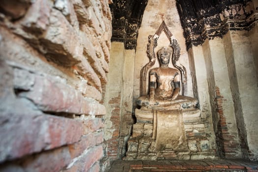 Old Buddha statue in Chaiwatthanaram temple. Ayutthaya, Thailand.