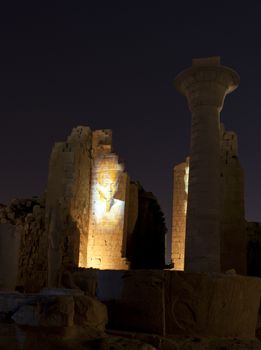 Ancient egyptian temple of Karnak in Luxor lit up at night during the sound and light show