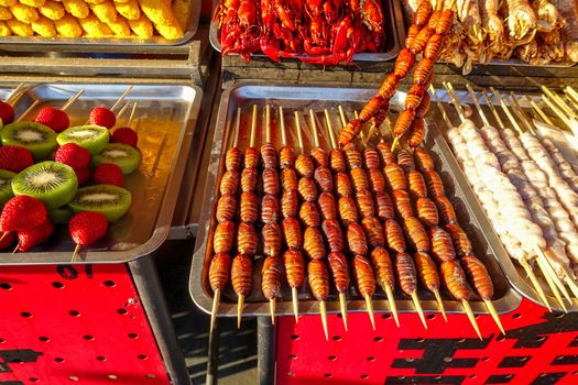 Exotic snacks and desserts can be found in this famous market Donghuamen Night food market near Wangfujing street, Beijing, China
