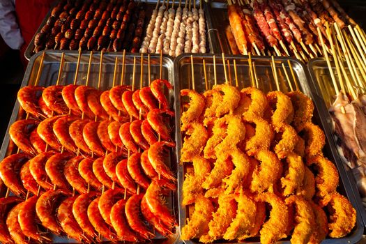 Exotic snacks and desserts can be found in this famous market Donghuamen Night food market near Wangfujing street, Beijing, China