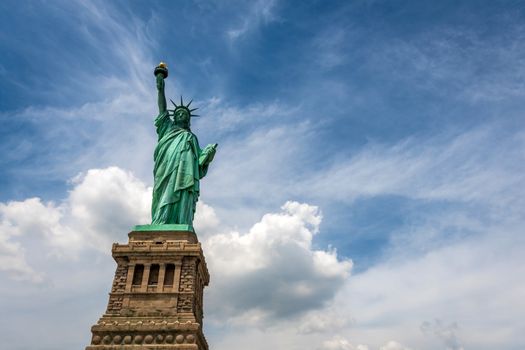 Statue of Liberty on Liberty Island closeup with blue sky in New York City Manhattan - Image