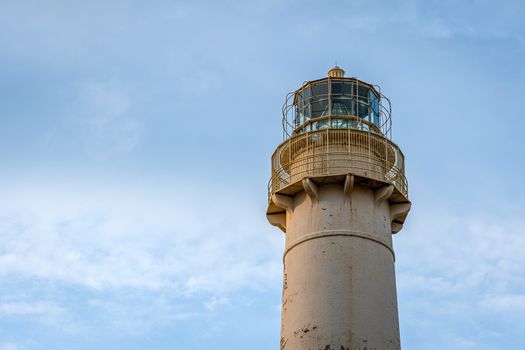 Lighthouse on a light blue sky background