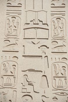 Ancient Egyptian hieroglyphic carvings on a temple wall at Karnak in Luxor
