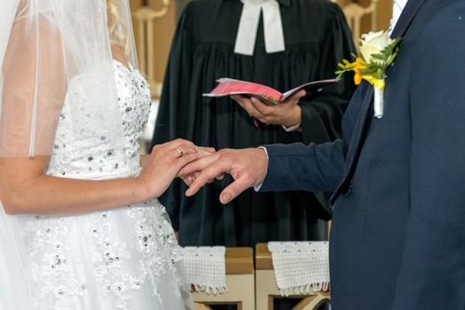 The bride and groom exchange with rings.