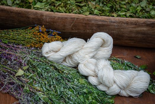 white yarn, dry flowers and grass  in the background at the country house - image