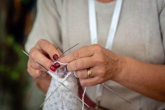 Close up of the hands of an elderly woman knitting. - Image