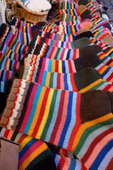 In the market a wide selection of different colored hand-knitted socks.