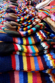 In the market a wide selection of different colored hand-knitted socks.