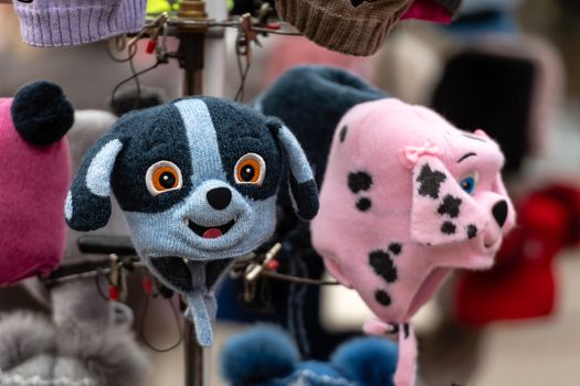 Colored knitted childrens hats with different animal faces.