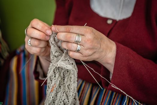 Close up of the hands of an elderly woman knitting. - Image