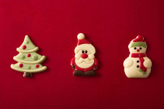 Christmas chocolate bonbons on red background
