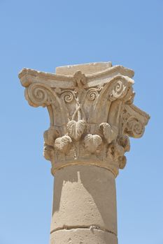 Carvings at the top of an ancient roman column at an egyptian temple