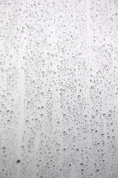 Drops of rain on the inclined window (glass). Shallow DOF