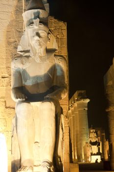 Statue at night in Luxor Temple of Ramses II with columns