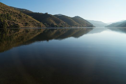 Scenic view of the Douro Valley and river with terraced vineyards near the village of Tua, Portugal