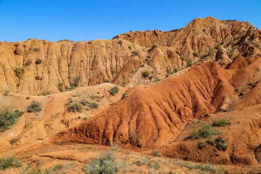 Red sandstone rock formations Seven bulls and Broken heart, Jeti Oguz canyon in Kyrgyzstan, Issyk-Kul region, Central Asia