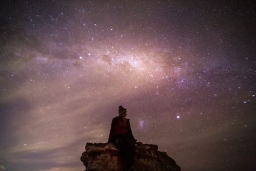 Sitting under the wondrous luminous night sky, stars twinkling through wispy high cloud. High ISO ten second exposure