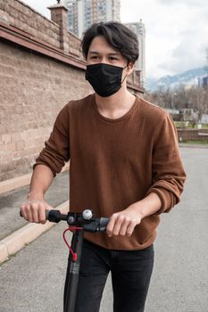 Young man riding a scooter in the city