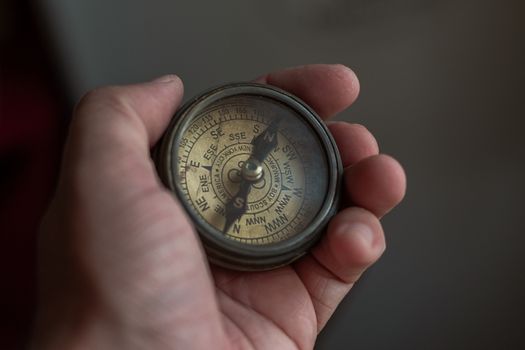 Close-Up Of Hand Holding Navigational Compass