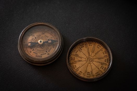 Compass on office desk table. Top view with copy space