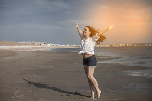 Sexy woman on beach smiling and enjoying a sunny, relaxing day at resort