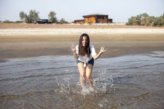 Woman splashing in a heavenly sea