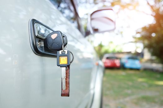 Close up of car key in the key hole for the ignition. Starting macro modern car key.