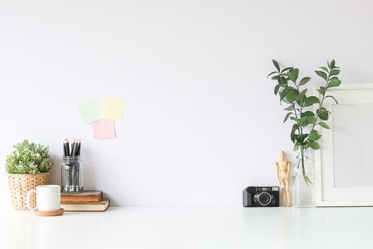 Mockup workspace desk and copy space books,plant and coffee on white desk.