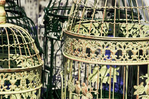 Antique bird cages decorated with ornaments at a flea market, Germany