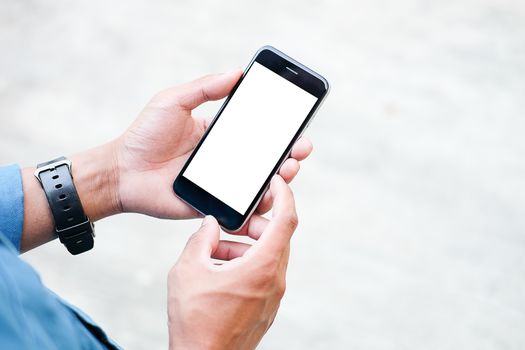 Cropped shot view of man hands holding smart phone with blank copy space screen for your text message or information content, female reading text message on cell telephone during in urban setting. 