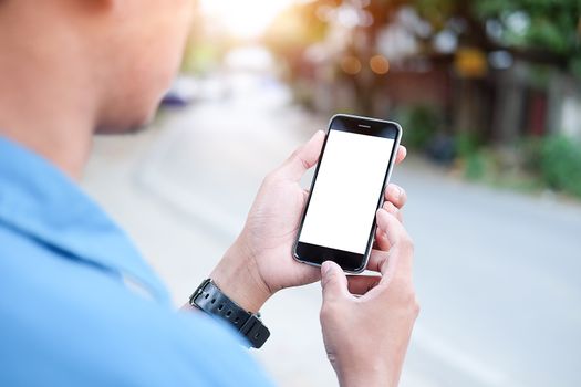 Cropped shot view of man hands holding smart phone with blank copy space screen for your text message or information content, female reading text message on cell telephone during in urban setting. 