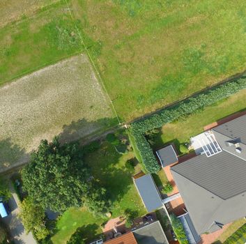 Plots with a meadow, a lawn, a detached house and a terraced house adjoin at one point, plot boundaries look like an abstract cross, Germany