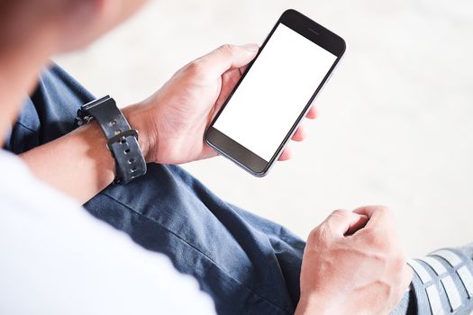 Cropped shot view of man hands holding smart phone with blank copy space screen for your text message or information content, female reading text message on cell telephone during in urban setting. 