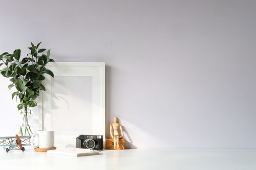 Mockup workspace desk and copy space books,plant and coffee on white desk.
