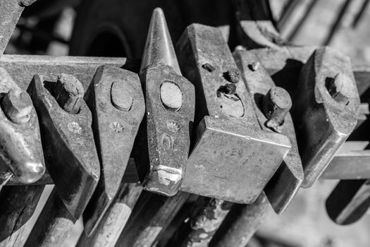 Historical tools of a blacksmith at a medieval market such as hammer, chisel, broach, chisel, beating plate, pestle, axe, pliers, axe, iron, in Germany