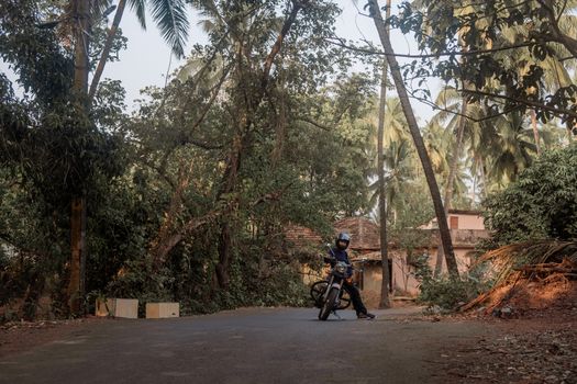 A Man On Motorcycle On Road in GOA village