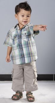 Portrait studio photo shoot of young mixed race asian child isolated on a blue background