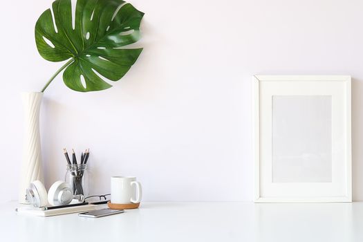 Mockup workspace desk and copy space books,plant and coffee on white desk.
