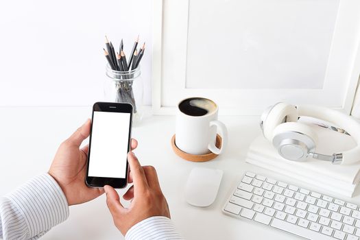 Cropped shot view of man hands holding smart phone with blank copy space screen for your text message or information content, female reading text message on cell telephone during in urban setting. 
