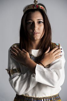 Beautiful young brunette girl posing in studio wearing egyptian clothing fancy dress