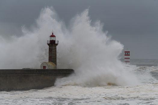 Waves crashing over Porto Lighthouse in a storm