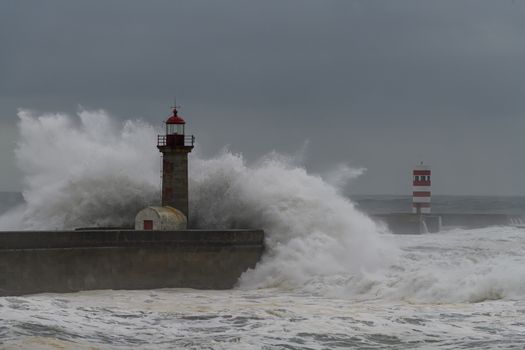 Waves crashing over Porto Lighthouse in a storm