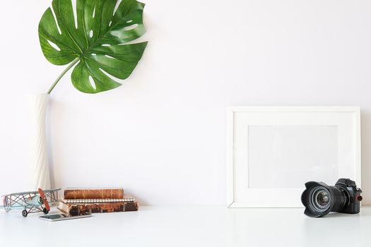 Mockup workspace desk and copy space books,plant and coffee on white desk.
