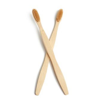 two wooden toothbrushes on a white background, plastic rejection concept, zero waste 