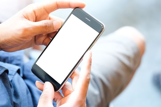 Cropped shot view of man hands holding smart phone with blank copy space screen for your text message or information content, female reading text message on cell telephone during in urban setting. 
