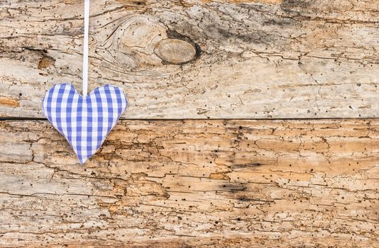 Rustic blue heart on vintage wooden background with copy space