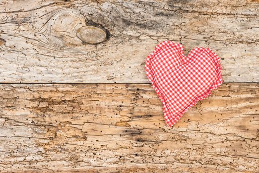 Romantic red heart on rustic old wood background for Valentine card with copy space

