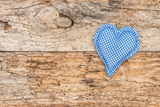 Blue heart on vintage wooden background with copy space