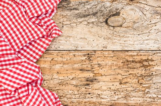 Vintage wooden table background rustic texture, with red checkered tablecloth, high angel view

